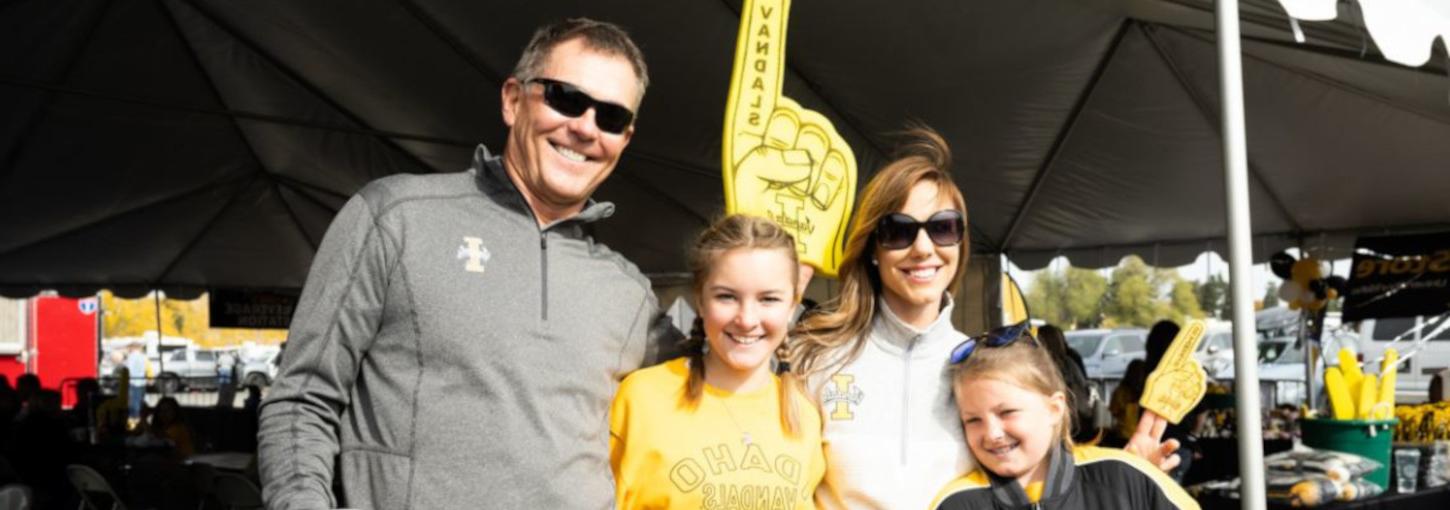 A family of four showing off their Vandal Gear at a tailgate event