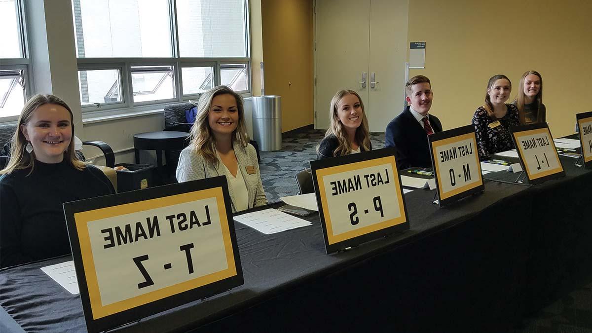 Interns at Etiquette Dinner check-in