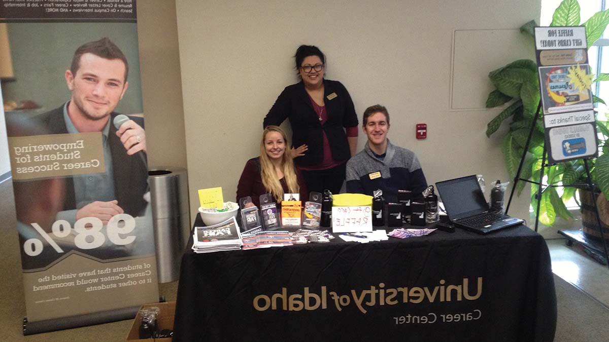 Interns at the 'Drive By Resume' and gift card raffle table in the ISUB