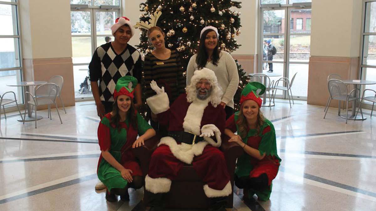 Several interns including a few dressed as elves at the Free Photos with Santa event