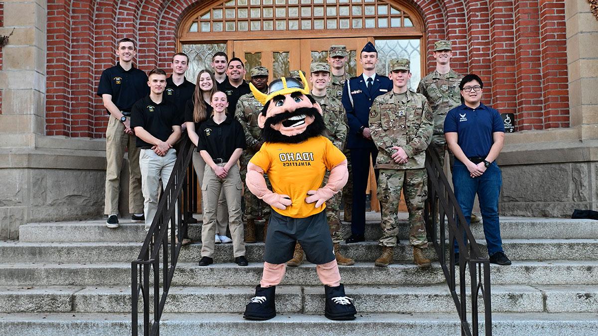 Joe Vandal poses with members of the military on the northern steps of the Administration Building.