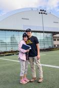 A mother and son stand on the practice field 的 ASUI-Kibbie Activity Center.